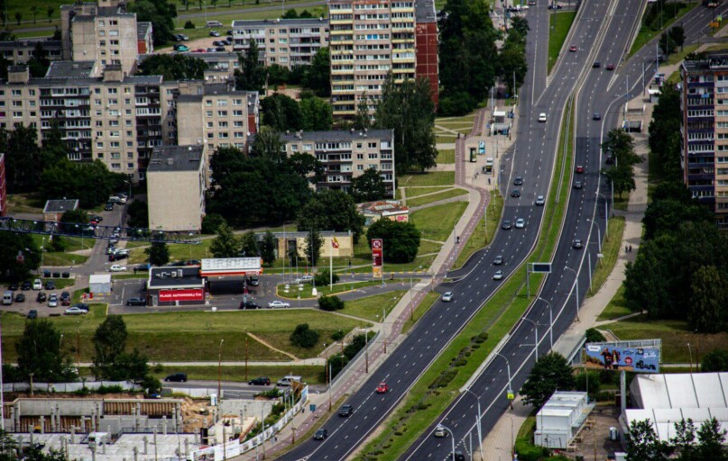 cars on road near high rise buildings during daytime
