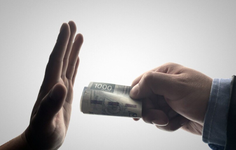 a person holding a stack of cash