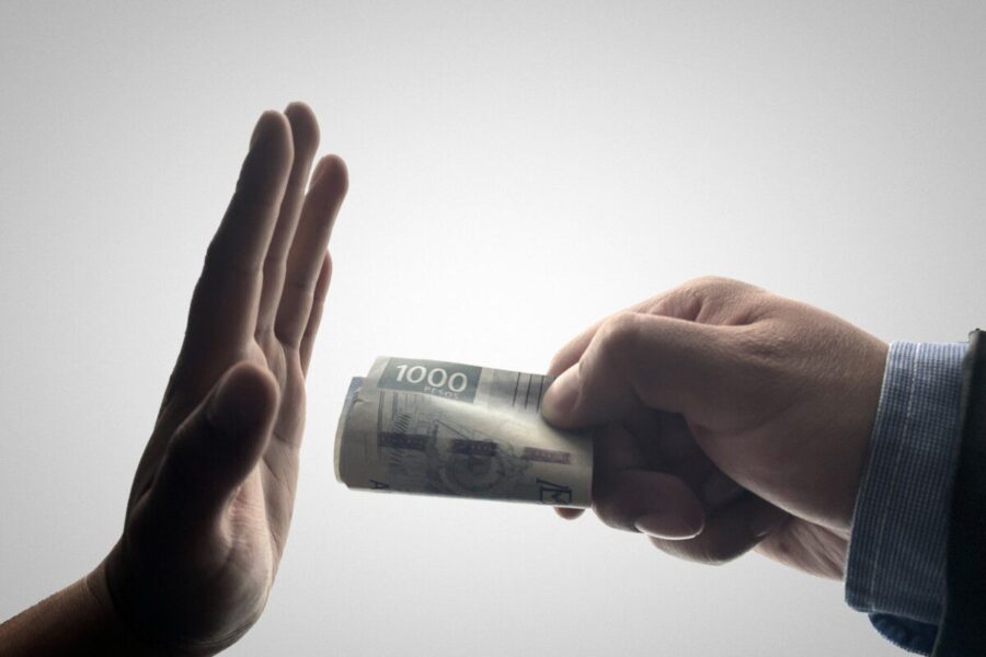 a person holding a stack of cash