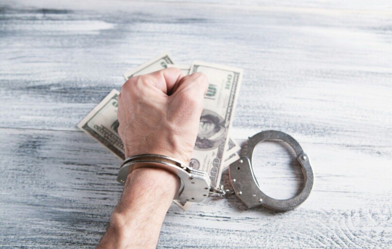 person holding silver ring on 100 us dollar bill