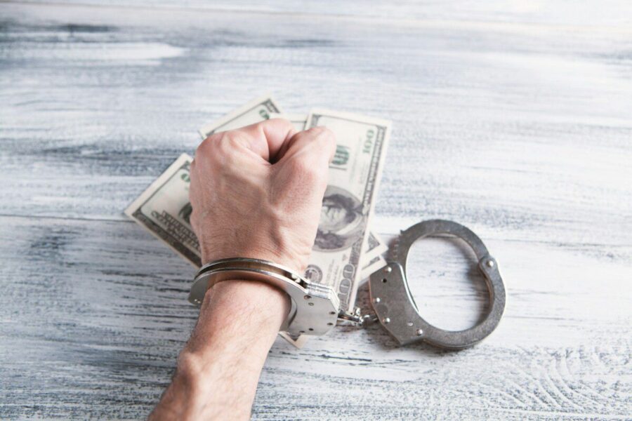 person holding silver ring on 100 us dollar bill
