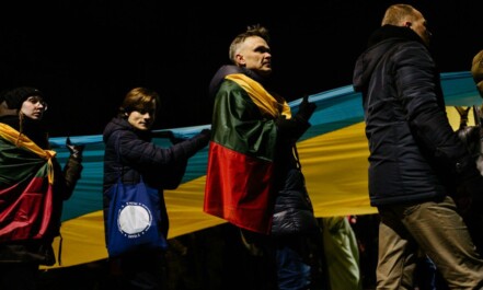 a group of people standing around each other