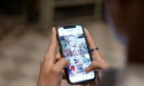 a person holding a cell phone in their hand