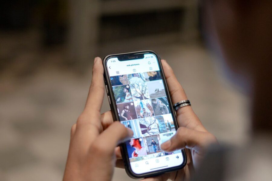 a person holding a cell phone in their hand