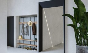 a room with a plant and a coat rack