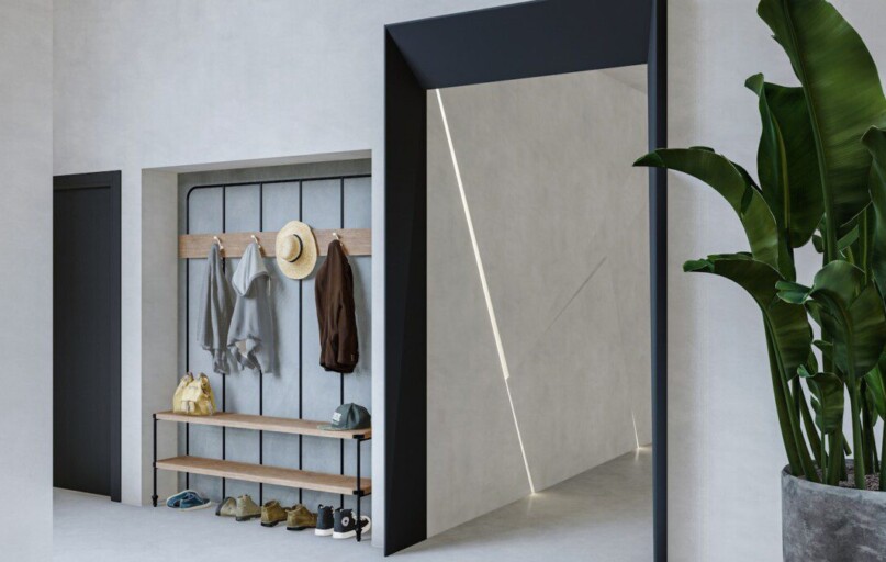 a room with a plant and a coat rack