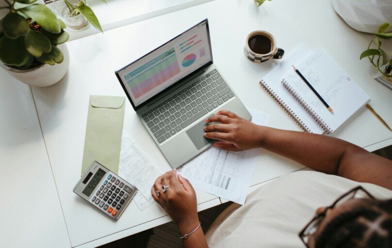 a person sitting at a table with a laptop