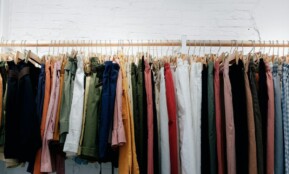 assorted-color clothes lot hanging on wooden wall rack
