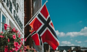 a flag is flying in front of a building