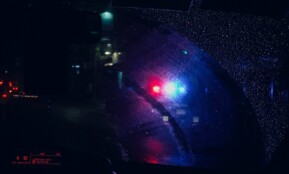 a close up of a car's rear view mirror at night