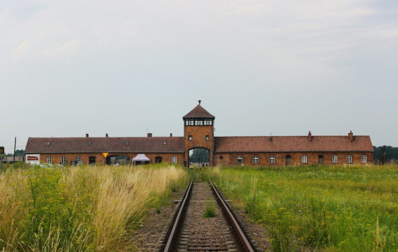 brown concrete building near train rail during daytime