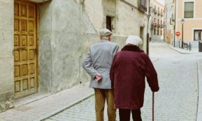 man and woman walking near closed wooden door