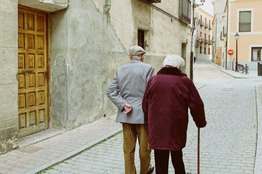 man and woman walking near closed wooden door