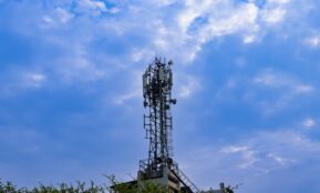 a tower with a cell phone on top of it