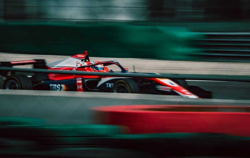 a man driving a race car on a track