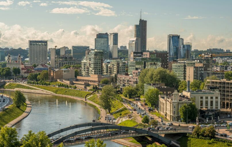 a river with a bridge and buildings