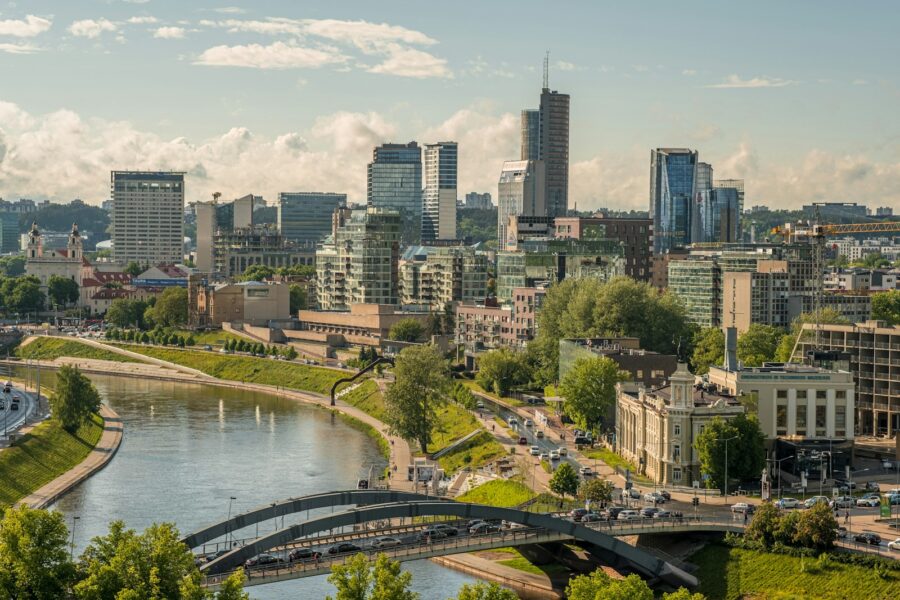 a river with a bridge and buildings