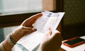 person holding white printer paper