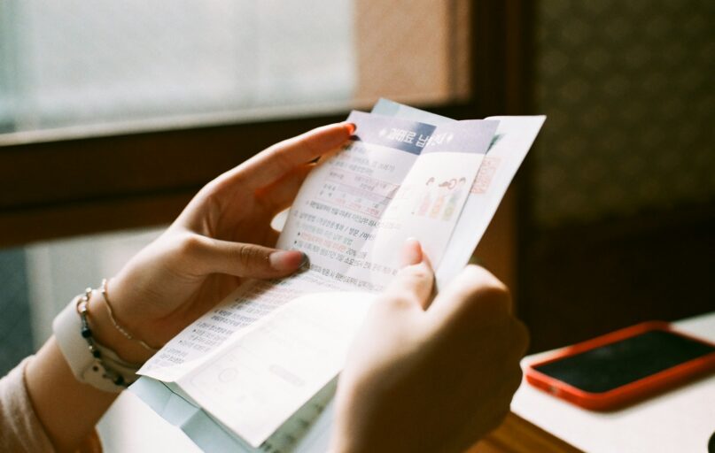 person holding white printer paper