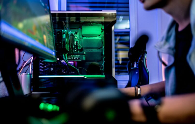 a man sitting in front of a computer monitor