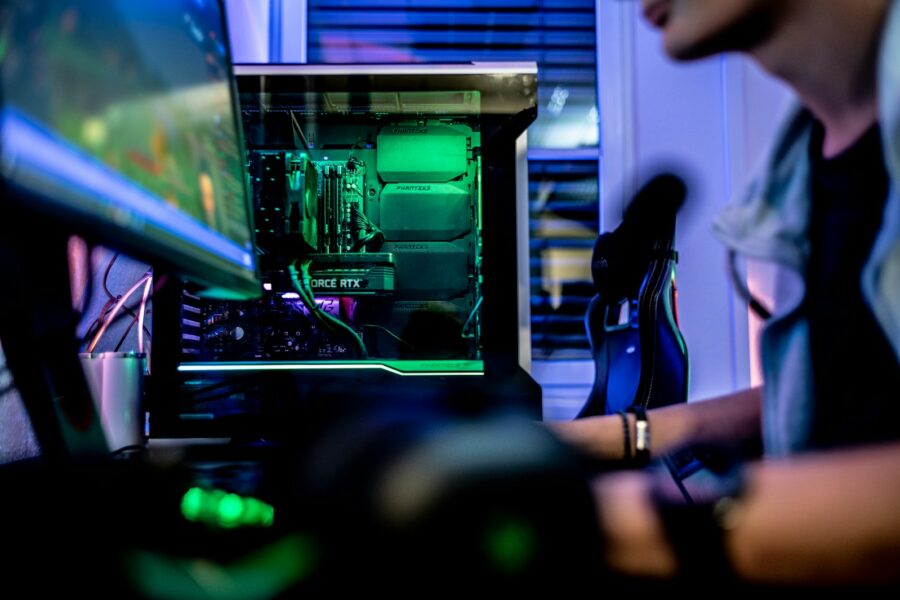 a man sitting in front of a computer monitor