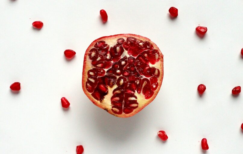 red sliced fruit on white surface