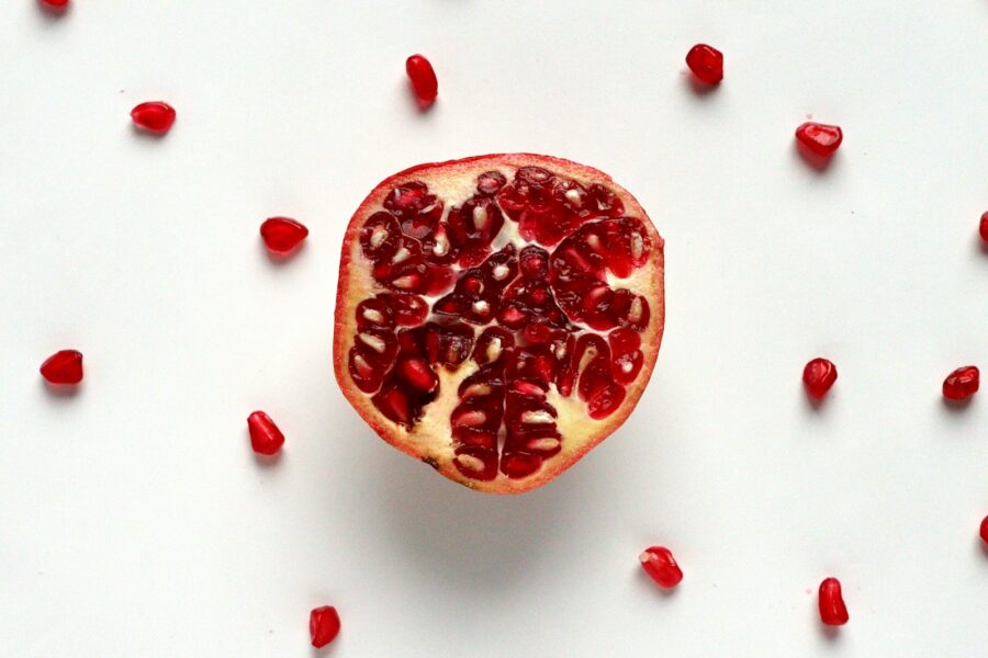 red sliced fruit on white surface