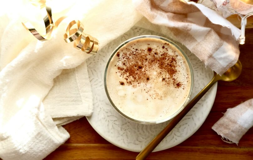 A close-up of a creamy beverage dusted with cinnamon.