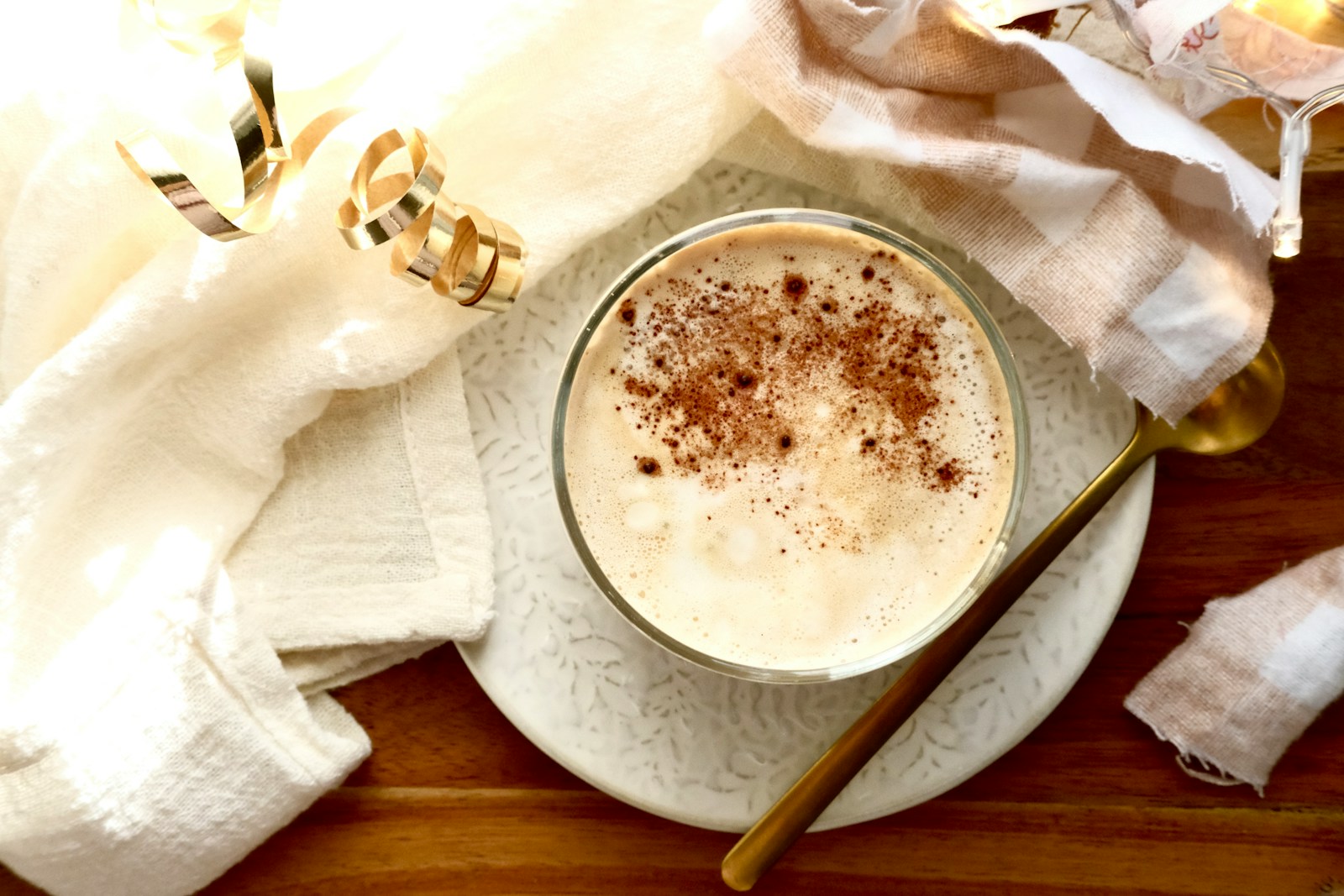A close-up of a creamy beverage dusted with cinnamon.