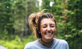 woman smiling near tree outdoor during daytime