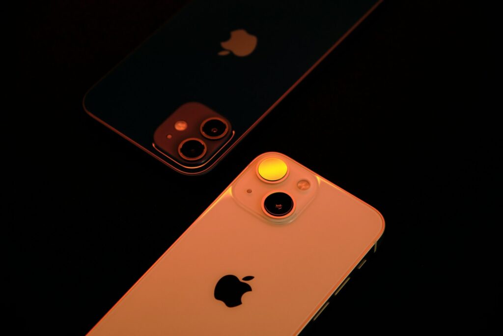two iphones sitting next to each other on a table