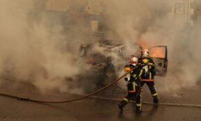 man in yellow and red suit holding black and yellow hose