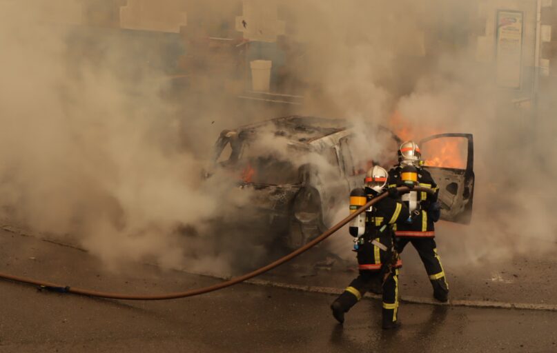 man in yellow and red suit holding black and yellow hose