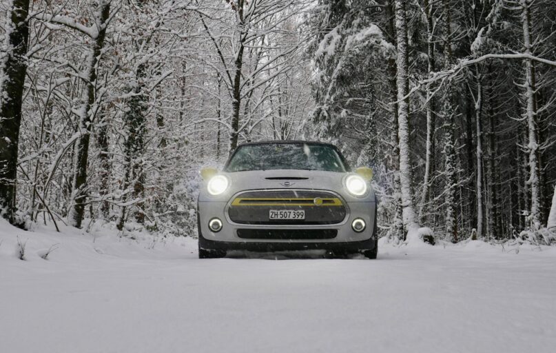a car driving down a snow covered road