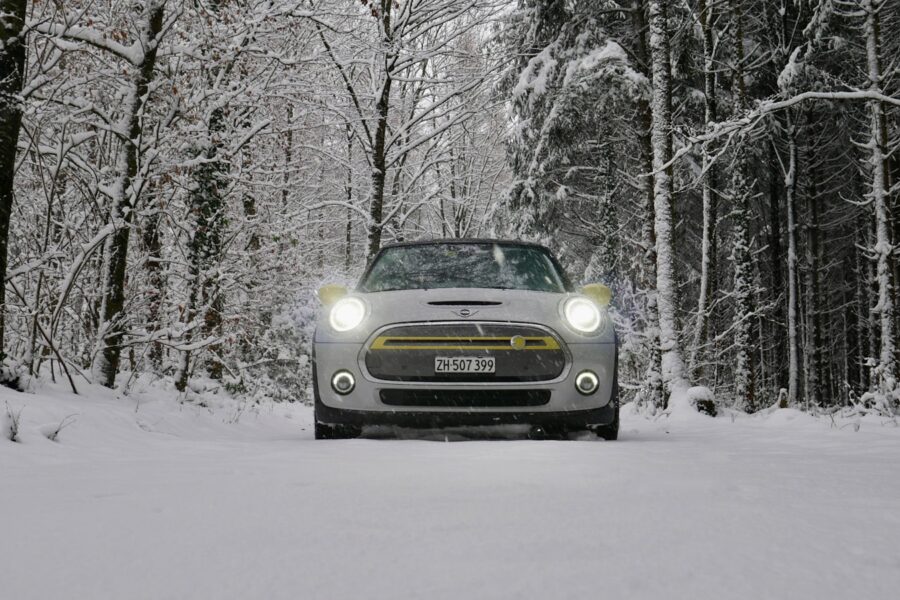a car driving down a snow covered road