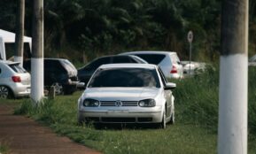 A white car parked on the side of a road