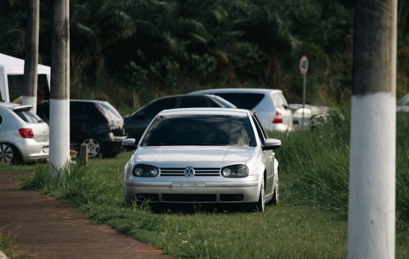 A white car parked on the side of a road
