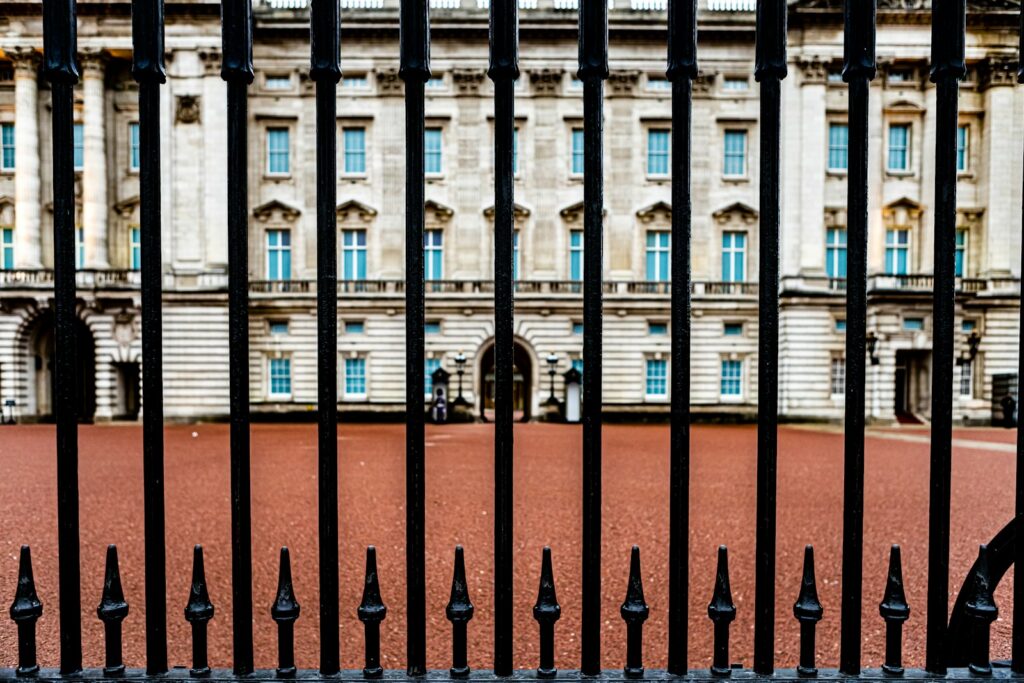black metal fence near brown concrete building during daytime