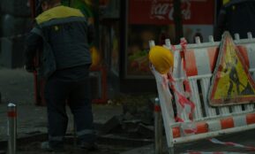 Construction workers and safety barriers on street