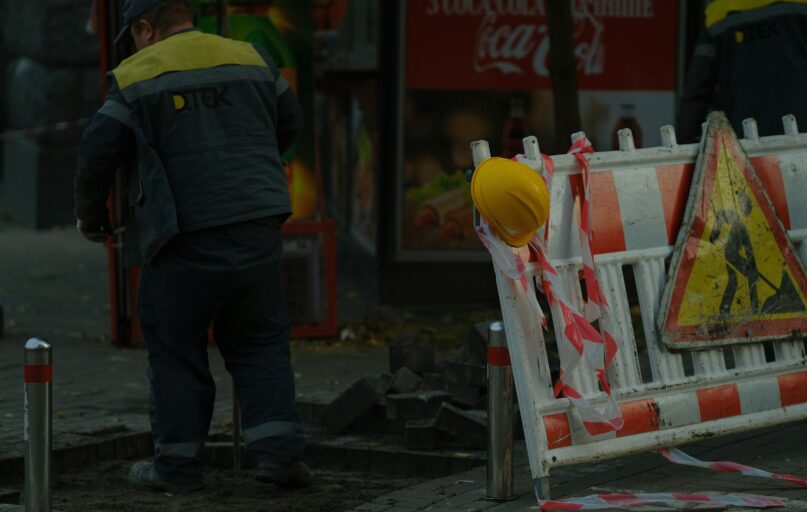 Construction workers and safety barriers on street