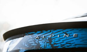 a close up of a blue and black car with the word alpine on it