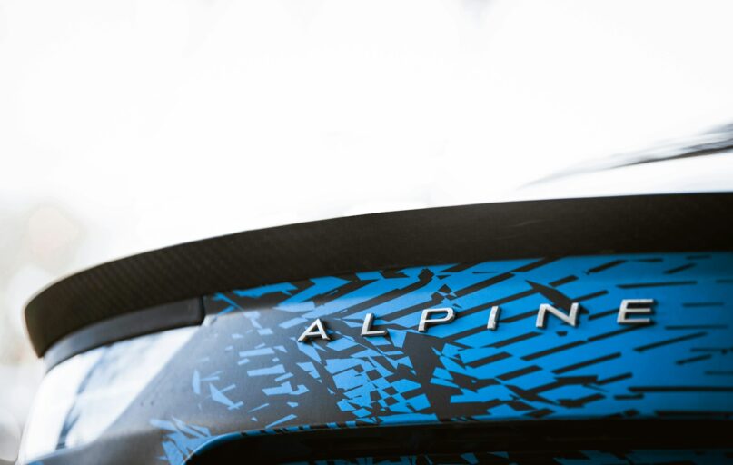 a close up of a blue and black car with the word alpine on it