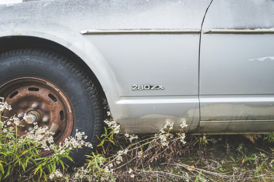 a car is parked in a field of flowers