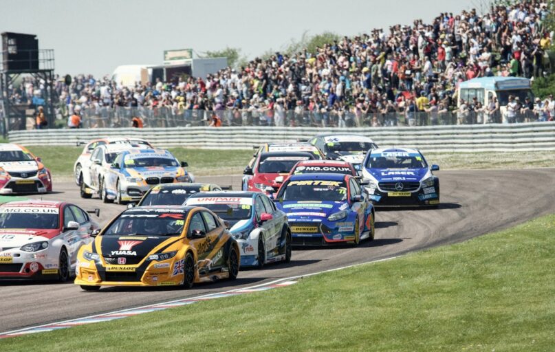 blue and red racing cars on track during daytime