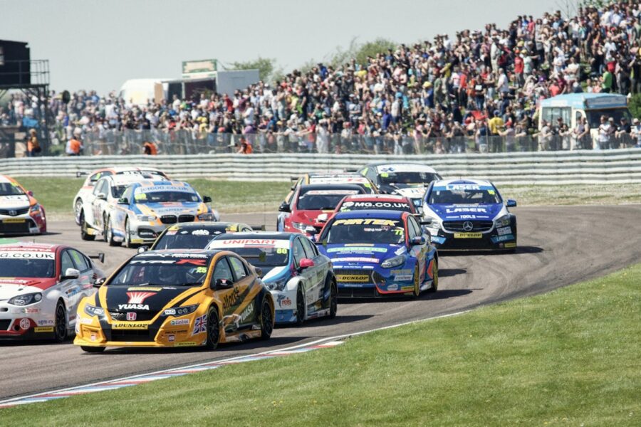 blue and red racing cars on track during daytime