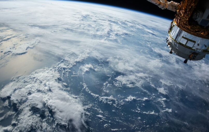 view of Earth and satellite