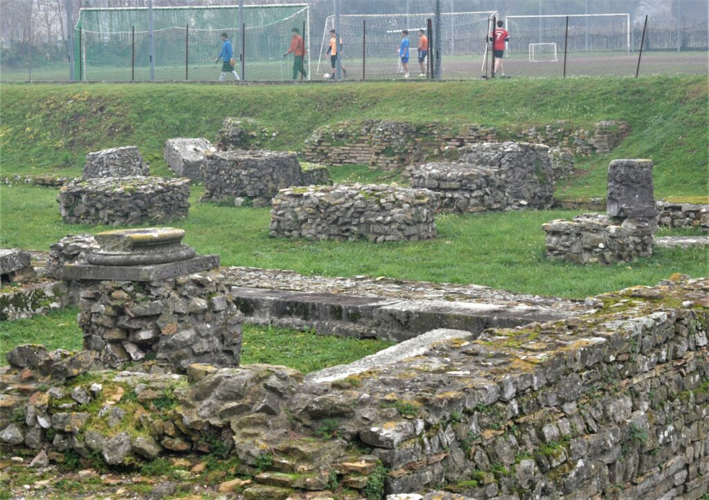 a group of people standing around a stone structure