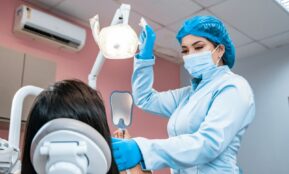 a woman getting her teeth checked by a dentist