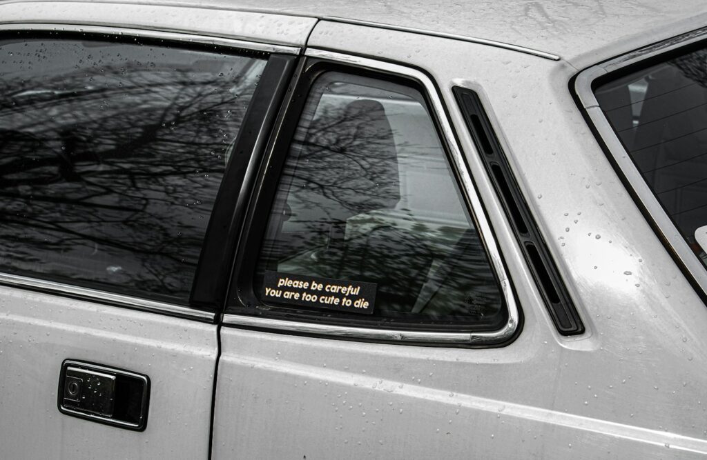 a white car with a sticker on it's side window