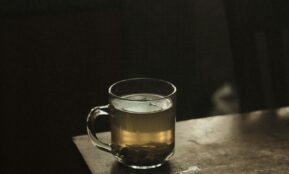 clear glass mug with brown liquid